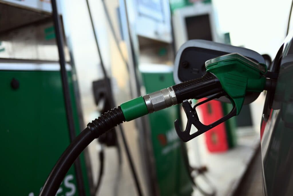 A fuel pump nozzle inserted into a car at a filling station