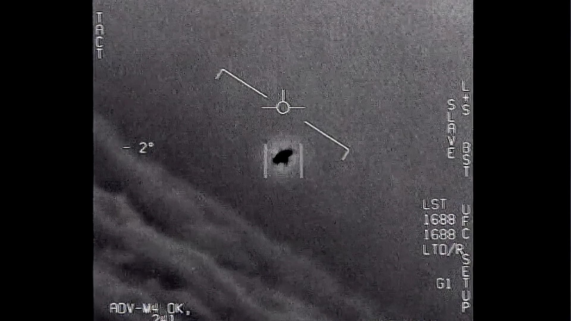 Grainy black and white military targeting footage showing an unidentified oval shaped object, released by the US Defence Department