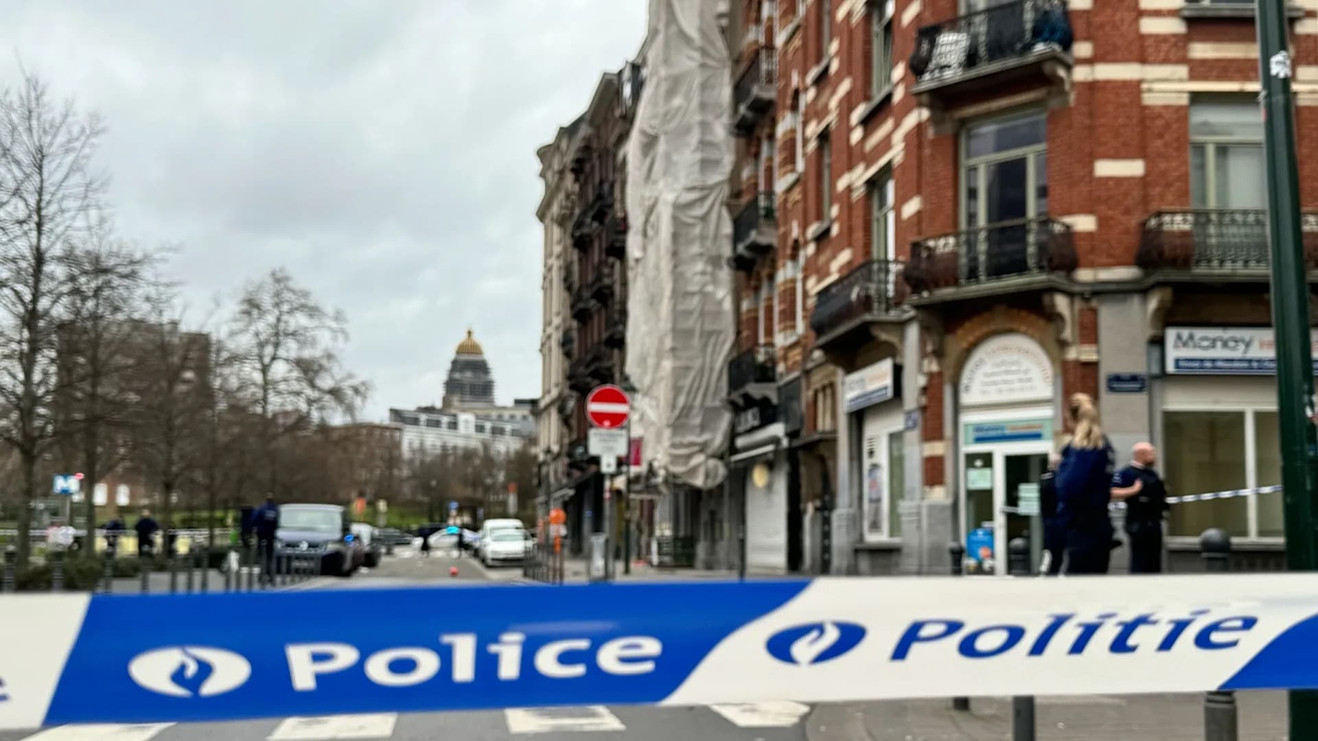 Police tape reading Police Politie stretched across a cordoned off Brussels street