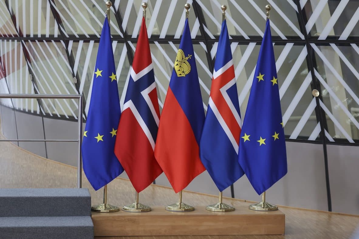 The flags of the European Union, Norway, Liechtenstein and Iceland displayed together on a stage