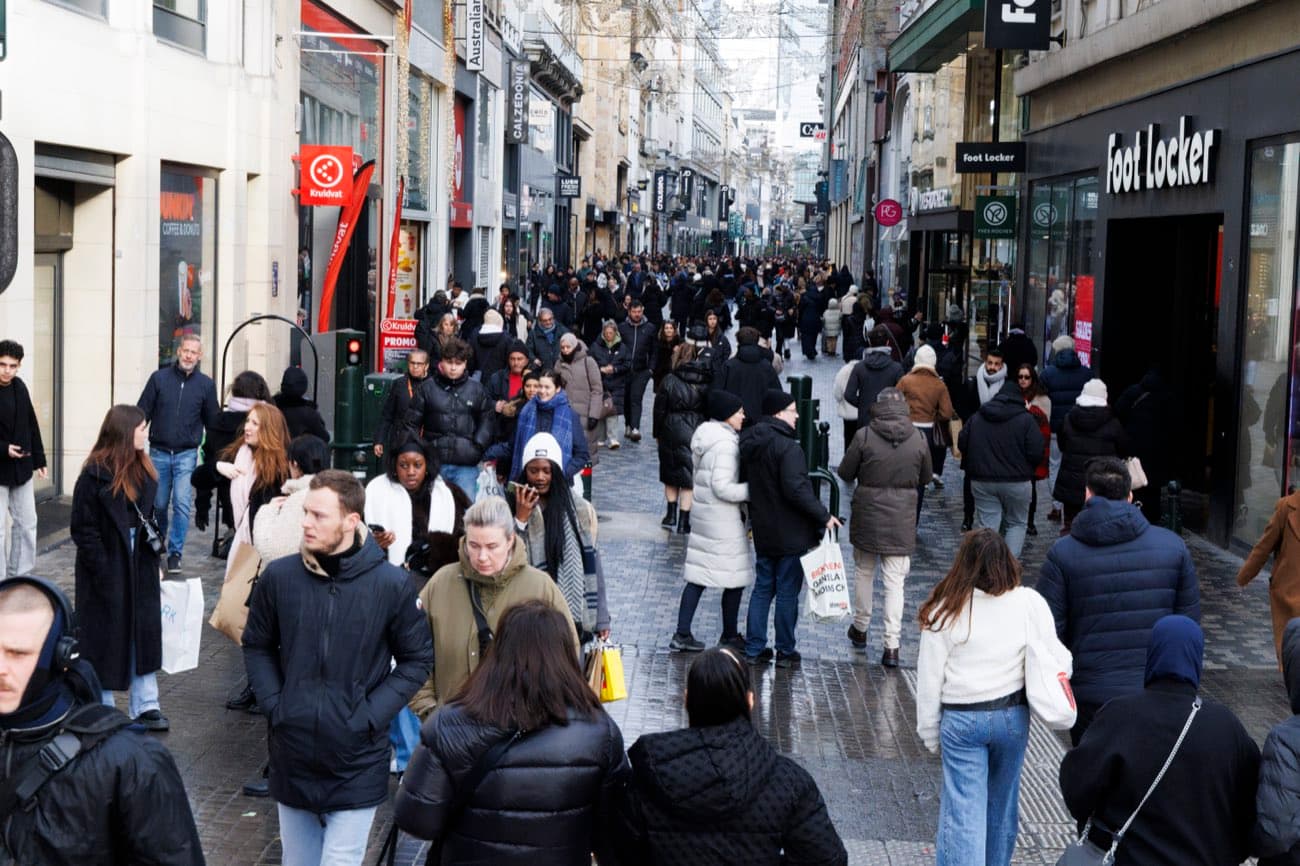 Shoppers crowd Rue Neuve, a pedestrian shopping street in central Brussels, on a winter afternoon