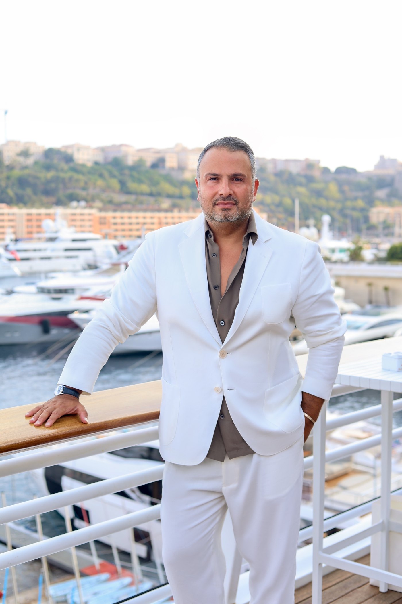 Maxim Berin on a terrace overlooking the Monaco marina
